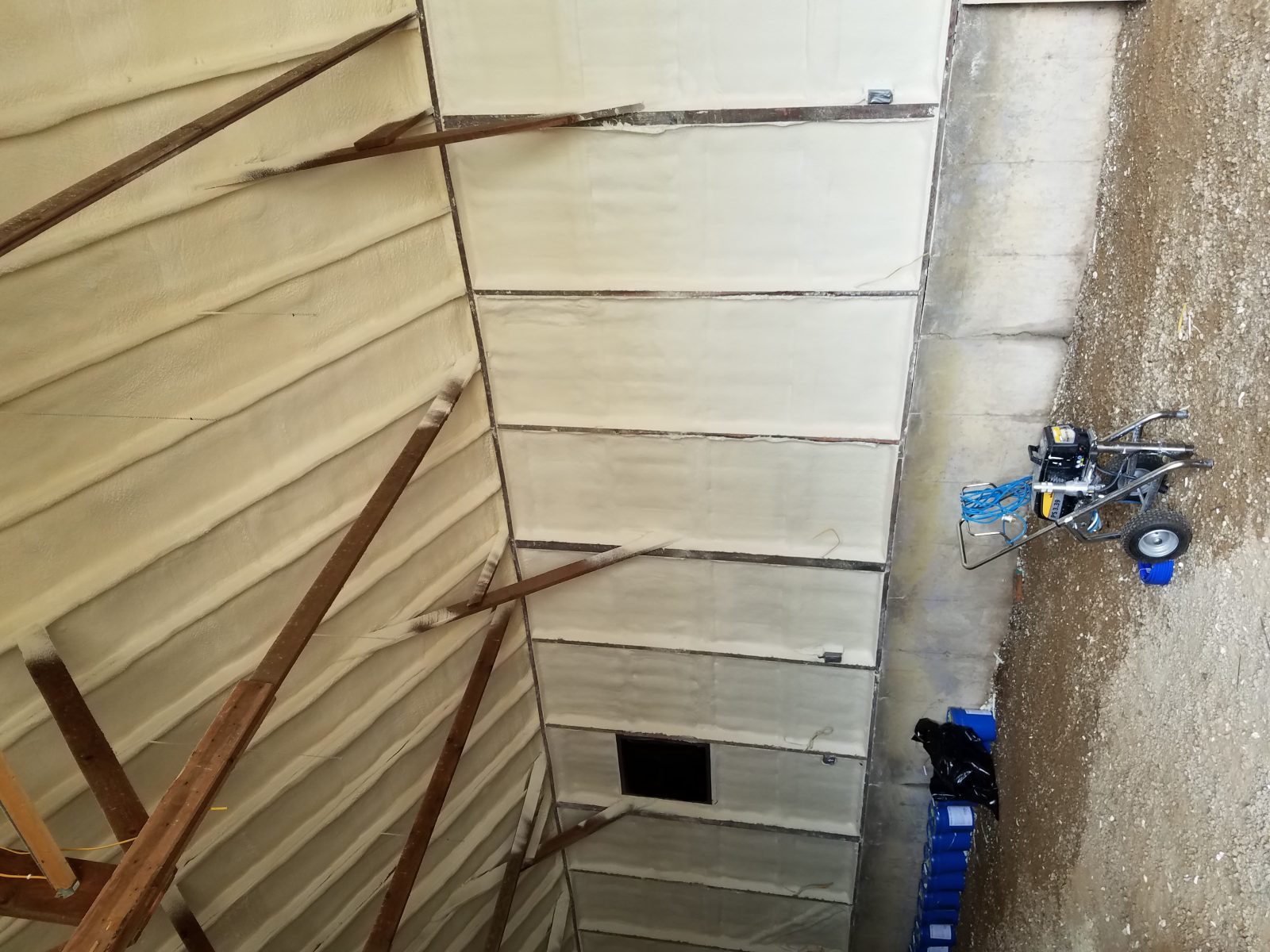 Spray foam insulation on a roofline assembly